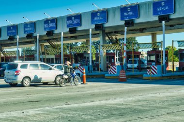 buenos aires, Argentina - 27 October 2022: cars and a motorcycle driving on highway and arriving at a toll station