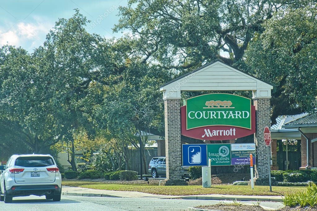 Charleston, united states - november 7 2022: the sign of courtyard by marriott hotel chain outside a long a road