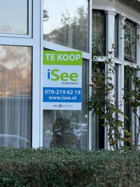 Den Haag, Hollanda - 24 Ekim 2024: Bir gayrimenkul tabelası potansiyel alıcıların iletişim bilgilerini içerdiğini gösteriyor