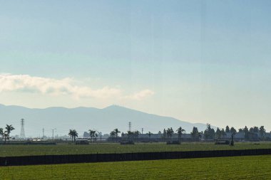 Oxnard, ABD - 23 Şubat 2020: Bir çiftçi Oxnard California 'da tarla sürmek için bir traktör kullanıyor ve toprağı meyve ve sebze yetiştirmeye hazırlıyor.