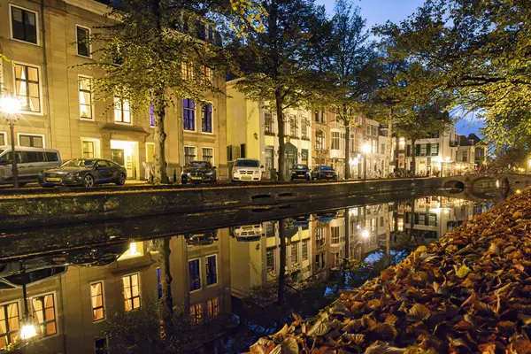 Lahey, Hollanda - 28 Eylül 2017: Tarihi Hollanda kanal evleri gece aydınlanıyor ve Lahey 'in suyuna güzel bir şekilde yansıtılarak barışçıl bir atmosfer yaratılıyor.