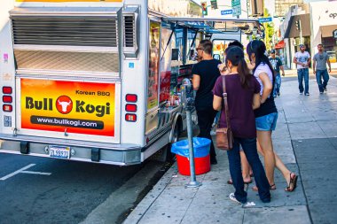 Los Angeles, ABD - 25 Ekim 2009: İnsanlar güneşli bir günde lezzetli sokak yemeklerinin tadını çıkarmak için Los Angeles 'taki popüler bir Kore BBQ yemek kamyonunun etrafında toplandılar.