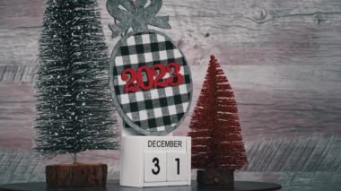 New Years Day on December 31 on a white wooden calendar in a New Years atmosphere. New year date 2023 and winter atmosphere. Wooden calendar with an important event.
