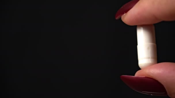 Woman Holds Capsule Pill Her Hands Close Black Background Girl — Stock videók