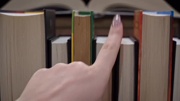 Young Girl Chooses Book Shelf Books Library Bookshelves Background Stack — Vídeos de Stock