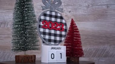 New Years Day on January 1st on a white wooden calendar in a New Years atmosphere. New year date 2023 and winter atmosphere. Wooden calendar with an important event.