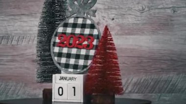 New Years Day on January 1st on a white wooden calendar in a New Years atmosphere. New year date 2023 and winter atmosphere. Wooden calendar with an important event.