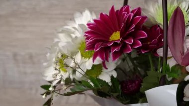 Flowers in a basket of chrysanthemums of different colors are spinning. Gift bouquet of flowers. Large beautiful flowers rotate and smell.