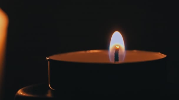 石蜡蜡烛在黑暗中被黄色的火焰点着 蜡烛中的一个大火把它烧黄了 房子里没有灯 是蜡烛发出的热量 片刻沉默 — 图库视频影像
