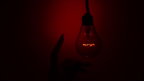 Light Bulb Turns Goes Out Touch Persons Hand Dark Slow — Vídeos de Stock