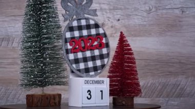 New Years Day on December 31 on a white wooden calendar in a New Years atmosphere. New year date 2023 and winter atmosphere. Wooden calendar with an important event.