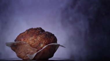 Appetizing chocolate muffin rotates and there is place for inscription on side. Delicious dessert spinning. Ready to eat cupcake with crispy crust on background. Dessert decorated with dark chocolate.