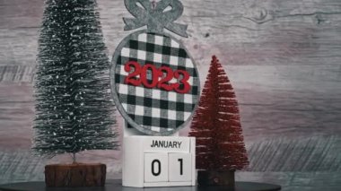 New Years Day on January 1st on a white wooden calendar in a New Years atmosphere. New year date 2023 and winter atmosphere. Wooden calendar with an important event.