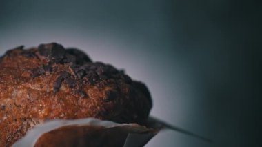 Appetizing chocolate muffin rotates and there is place for inscription on side. Delicious dessert spinning. Ready to eat cupcake with crispy crust on background. Dessert decorated with dark chocolate.