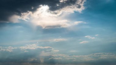 White fluffy clouds slowly float through the blue daytime sky timelapse. Beautiful skies are moving. Airy snow-white clouds move to the side.