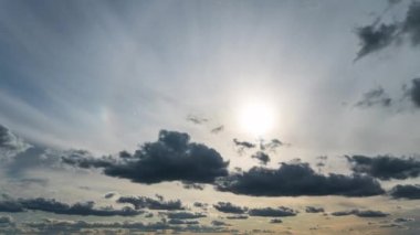 White fluffy clouds slowly float through the blue daytime sky timelapse. Beautiful skies are moving. Airy snow-white clouds move to the side.