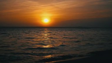 Deniz üzerinde gün batımı ufku. Suyun yanında. Gökyüzünde güzel bir akşam gün batımı manzarası. Güneşin yolu deniz yüzeyine yansır. Doğa. Nehir üzerinde güzel bulutlar.