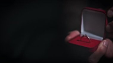 Adam gelinine nişan yüzüğü veriyor. Evlilik teklifi, evlilik ve bir çiftin nişanı. Bir adam sevgili karısına evlenme teklif eder. Yüzük masanın üzerindeki güzel bir kutuda..