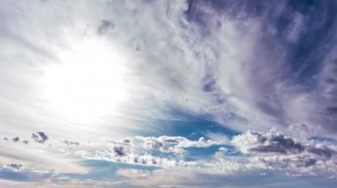White fluffy clouds slowly float through the blue daytime sky timelapse. Beautiful skies are moving. Airy snow-white clouds move to the side.
