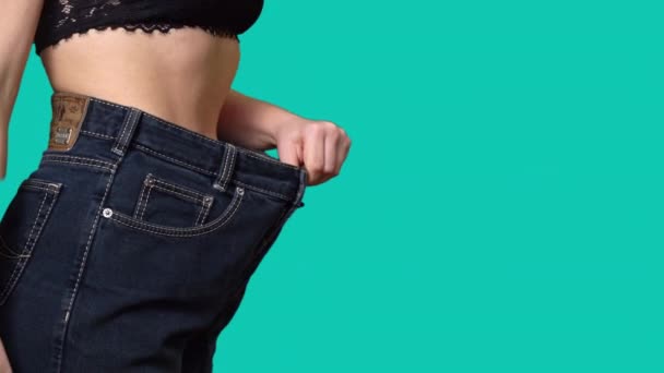 女性は大きなサイズのジーンズコピースペースで体重を減らした後ウエストします 成功した体重減少 適切な栄養 そして健康の概念 スリムな美しい女性の不在 大きなズボンの薄い女性 — ストック動画