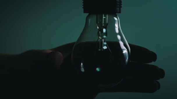 Light Bulb Turns Goes Out Touch Persons Hand Dark Slow — Stok Video