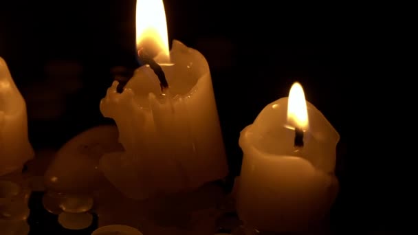 Three Paraffin Candles Burn Row Black Background Reflection Three White — Stock Video
