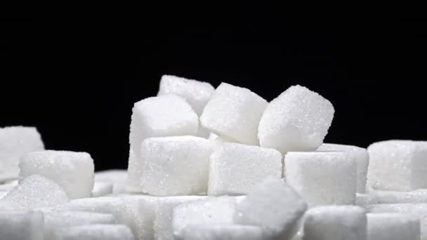 白色的糖块堆在黑色的背景上 糖果对健康有害 糖的概念是有害的 营养和饮食控制 糖尿病 甜食增重 — 图库视频影像