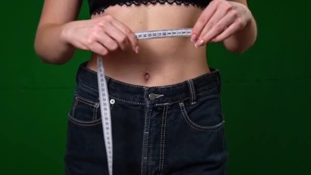 女性は測定テープで体重を減らした後 腰を測定します 適切な栄養 そして健康の概念 大きなズボンの中の薄い女性 成功した体重減少 — ストック動画