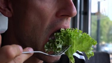 Kızarmış tavuk yiyen bir adamın yakın plan fotoğrafı..