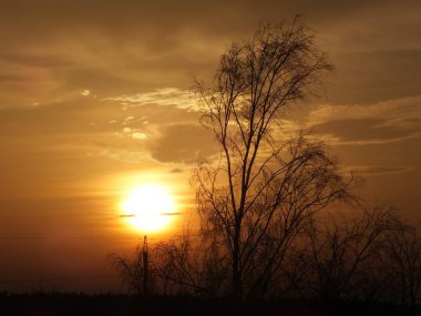 December sunset against the backdrop of warming in the Riga district of Bolderaja. clipart