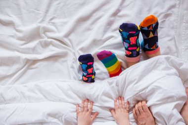 Colorful socks on feet as a symbol of World Down Syndrome Day.	