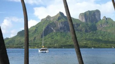 Turquoise blue lagoon in Bora Bora, Tahiti, French Polynesia. Cruising on a yacht around Bora Bora with a view of Mount Otemanu. Luxury travel vacation, romantic getaway, honeymoon exotic destination