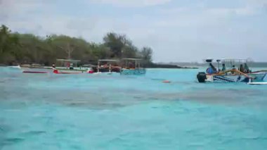 Turquoise blue lagoon in Bora Bora, Tahiti, French Polynesia. Cruising on a yacht around Bora Bora with a view of Mount Otemanu. Luxury travel vacation, romantic getaway, honeymoon exotic destination