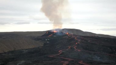4K footage of Fagradalsfjall active volcano eruption in Geldingadalir, Reykjanes, Iceland. River Of Hot Lava Flowing down the hill surrounded by smoke. Iceland Volcanic eruption Grindavik