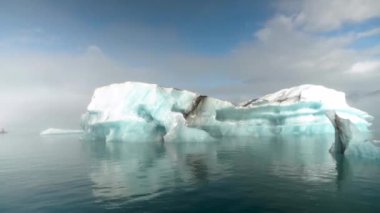 Jokulsarlon glacier Lagoon, Iceland. Stunning icebergs floating in lagoon hidden in the mist, powerful message of climate change in Iceland. High quality 4k footage.