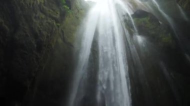 Powerful Gljufrabui or Gljufurarfoss hidden waterfall inside the cave near Seljalandsfoss in Iceland. High quality 4k footage