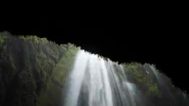 Powerful Gljufrabui or Gljufurarfoss hidden waterfall inside the cave near Seljalandsfoss in Iceland. High quality 4k footage