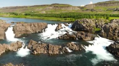 Glanni Waterfall during summer in Iceland. Magical Icelandic landscape with lush green bushes. High quality 4k footage