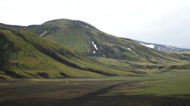 Iceland landscape with stunning mountains around Landmannalaugar. Iceland nature in a dramatic weather. Moss covered lava fields in Iceland. High quality 4k footage