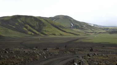 Iceland landscape with stunning mountains around Landmannalaugar. Iceland nature in a dramatic weather. Moss covered lava fields in Iceland. High quality 4k footage