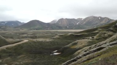 Iceland landscape with stunning mountains around Landmannalaugar. Iceland nature in a dramatic weather. Moss covered lava fields in Iceland. High quality 4k footage