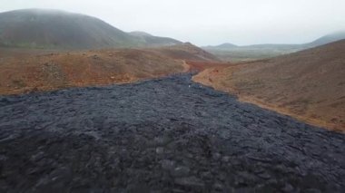 4K Aerial Drone footage of Cold Lava in Fagradalsfjall active volcano in Geldingadalir, Reykjanes, Iceland. River of Cold Lava Flowing down the hill. Lava field.