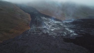 4K Aerial Drone footage of Cold Lava in Fagradalsfjall active volcano in Geldingadalir, Reykjanes, Iceland. River of Cold Lava Flowing down the hill. Lava field.