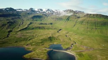 Aerial drone footage of an Icelandic green nature around Kirkjufell mountain in the snaefellsnes peninsula, during summer. High quality 4k footage