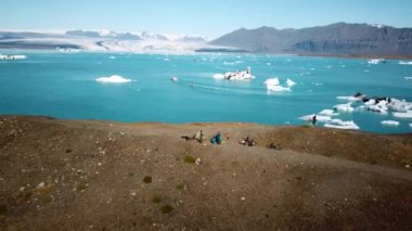 Aerial drone footage of icebergs floating in Jokulsarlon glacier lagoon in Iceland. Scenic view of Ice bergs. Artic nature ice landscape. Melting glacier in Iceland. Global warming, climate change.