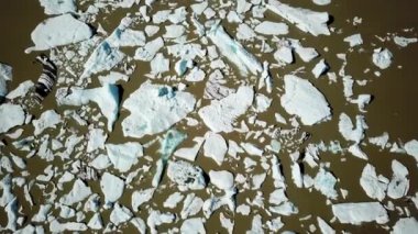 Aerial drone footage of Fjallsarlon glacier lagoon with plenty of icebergs floating in a lake, Iceland. Scenic view of Ice bergs. Artic nature ice landscape. Melting glacier in Iceland. Climate change
