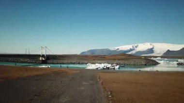Aerial drone footage of icebergs floating in Jokulsarlon glacier lagoon in Iceland. Scenic view of Ice bergs. Artic nature ice landscape. Melting glacier in Iceland. Global warming, climate change.