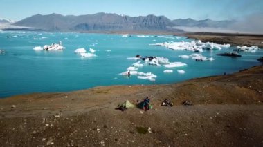 Aerial drone footage of icebergs floating in Jokulsarlon glacier lagoon in Iceland. Scenic view of Ice bergs. Artic nature ice landscape. Melting glacier in Iceland. Global warming, climate change.