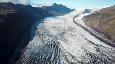 Aerial drone footage of Vatnajokull ice tongue. Skaftafell glacier with icebergs floating in a glacier lagoon. Scenic view of Vatnajokull. Artic nature ice landscape. Melting glacier in Iceland.