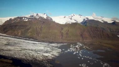 Aerial drone footage of Vatnajokull ice tongue. Skaftafell glacier with icebergs floating in a glacier lagoon. Scenic view of Vatnajokull. Artic nature ice landscape. Melting glacier in Iceland.
